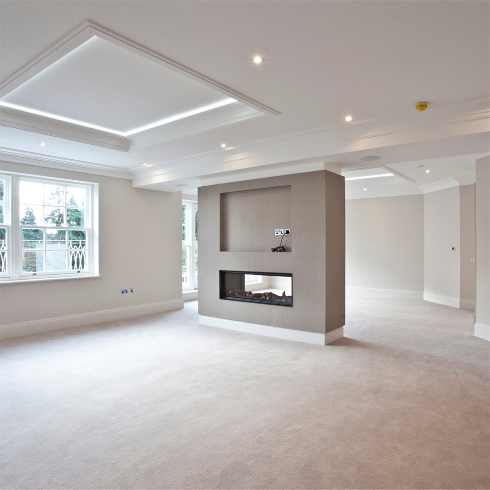 Wrap around living room fireplace: residential interior design by Studio G for a luxury contemporary residence in Cobham, Surrey