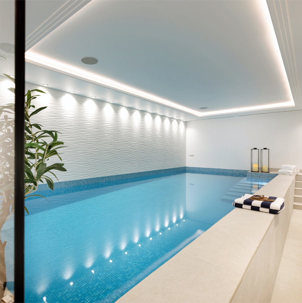 Private luxury indoor swimming pool: residential interior design by Studio G for a New England style home in Surrey