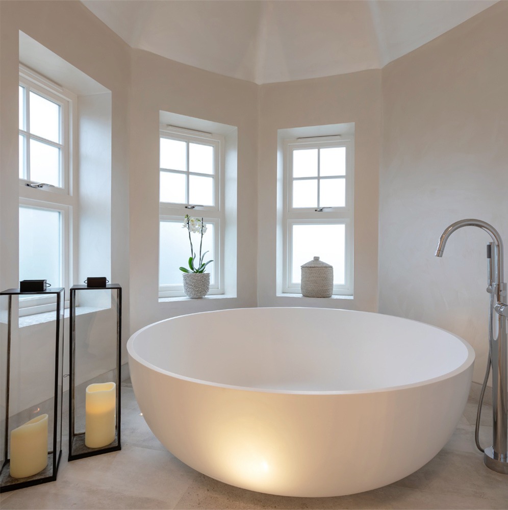Luxury oval bath tub: residential interior design by Studio G for a New England style home in Surrey